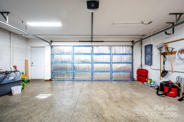 51 Sugar Hill Dr, Weaverville, NC 28787 - garage with concrete block wall, a garage door opener, and electric panel