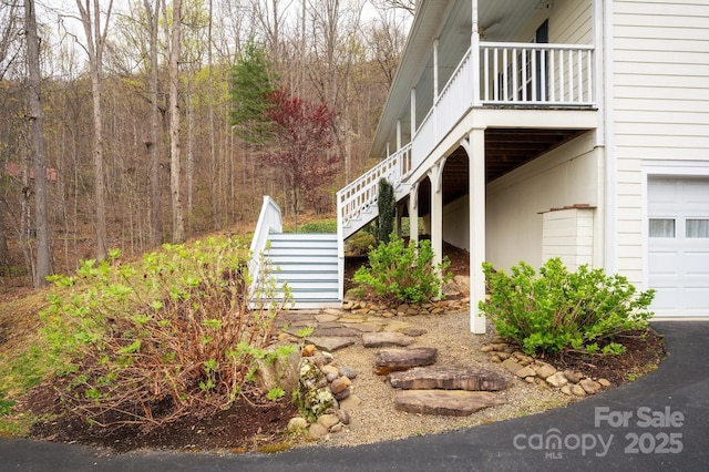 51 Sugar Hill Dr, Weaverville, NC 28787 - view of side of property featuring an attached garage, a view of trees, and stairs