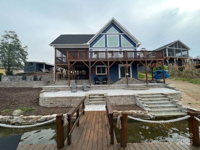 back of property featuring a patio area, stairway, and a wooden deck