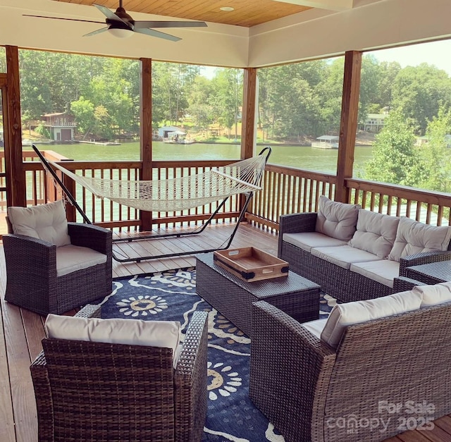 deck with outdoor lounge area and a ceiling fan