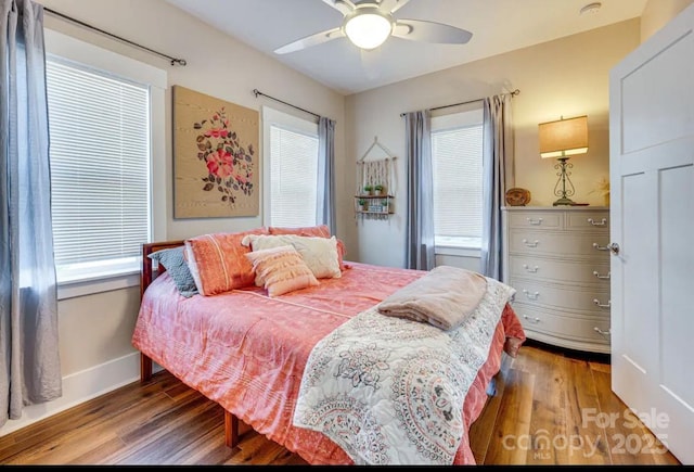 bedroom featuring wood finished floors, ceiling fan, and baseboards