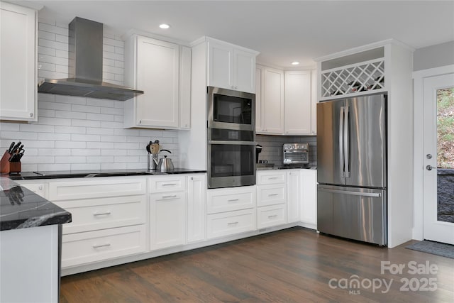 45 Atsadi Ct, Brevard, NC 28712 - kitchen featuring dark wood-style flooring, backsplash, white cabinets, wall chimney exhaust hood, and appliances with stainless steel finishes