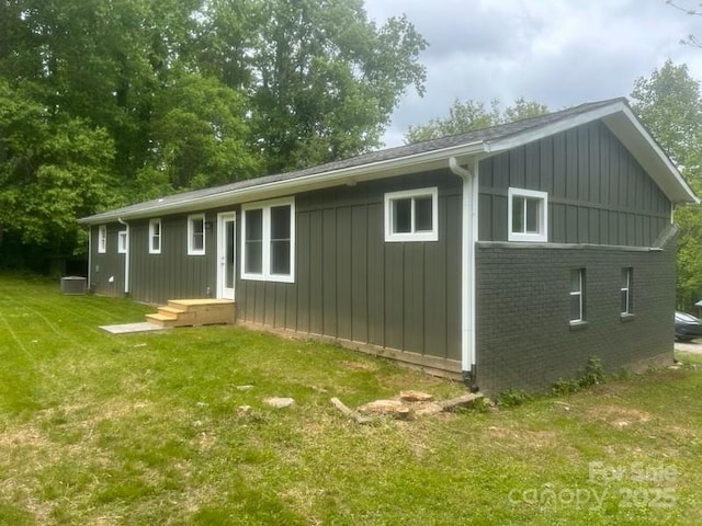 507 N Fork Rd, Black Mountain, NC 28711 - rear view of property featuring a lawn, board and batten siding, and brick siding