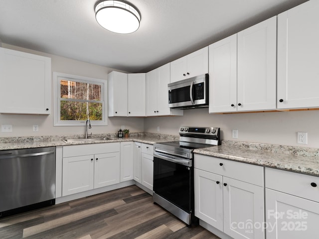 507 N Fork Rd, Black Mountain, NC 28711 - kitchen featuring stainless steel appliances, a sink, white cabinets, and dark wood-style floors
