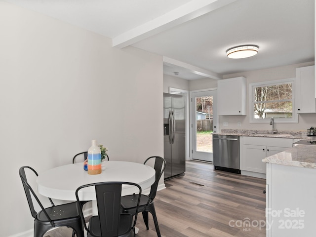 507 N Fork Rd, Black Mountain, NC 28711 - kitchen with stainless steel appliances, a sink, white cabinetry, wood finished floors, and baseboards