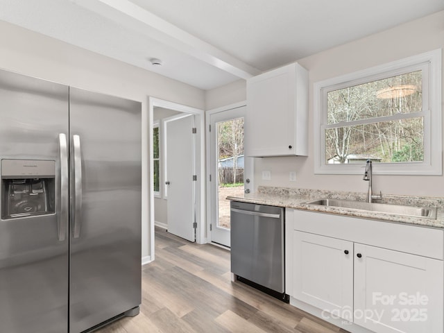 507 N Fork Rd, Black Mountain, NC 28711 - kitchen with stainless steel appliances, a sink, light wood finished floors, and white cabinetry