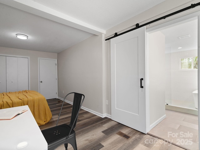 507 N Fork Rd, Black Mountain, NC 28711 - office featuring a barn door, wood finished floors, and baseboards