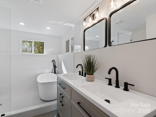 507 N Fork Rd, Black Mountain, NC 28711 - bathroom featuring a soaking tub, double vanity, a walk in shower, recessed lighting, and tile walls