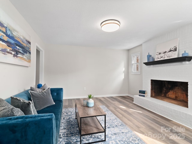507 N Fork Rd, Black Mountain, NC 28711 - living room featuring wood finished floors, a fireplace, and baseboards