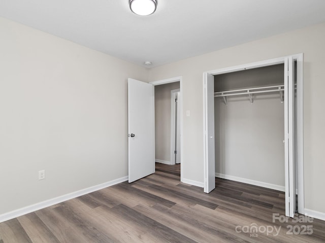 507 N Fork Rd, Black Mountain, NC 28711 - unfurnished bedroom with wood finished floors, baseboards, and a closet