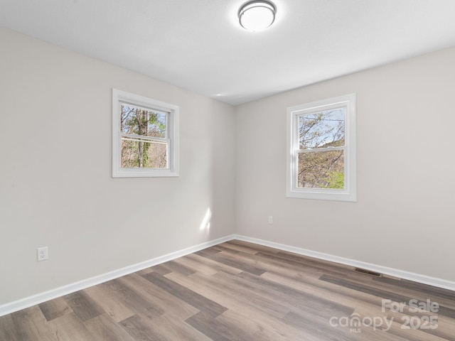 507 N Fork Rd, Black Mountain, NC 28711 - empty room featuring plenty of natural light, wood finished floors, and baseboards