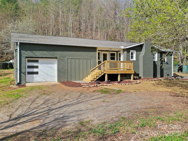 507 N Fork Rd, Black Mountain, NC 28711 - view of front of house with brick siding, driveway, and a wooden deck