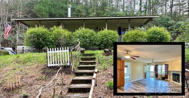 exterior space featuring fence, stairs, and a ceiling fan
