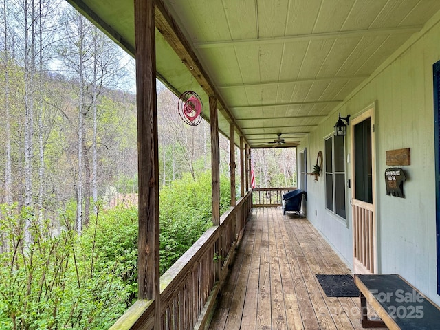 wooden deck with a porch and ceiling fan