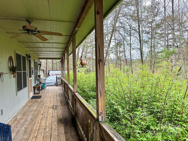 wooden deck featuring a ceiling fan
