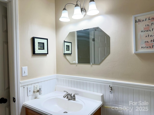 bathroom with vanity and wainscoting