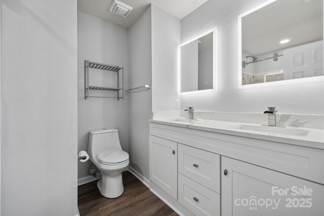 4211 Center Place Dr, Harrisburg, NC 28075 - full bath with toilet, a sink, double vanity, and wood finished floors