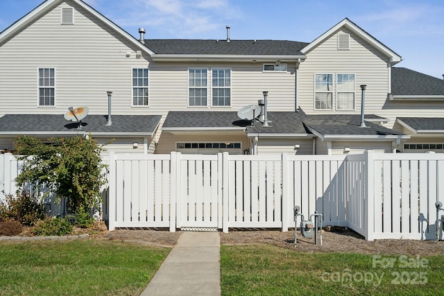 4211 Center Place Dr, Harrisburg, NC 28075 - back of property featuring a garage, fence, and roof with shingles