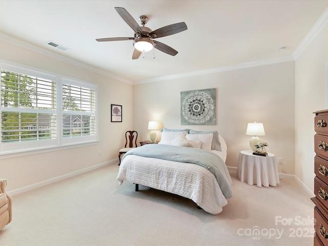 carpeted bedroom with visible vents, crown molding, baseboards, and a ceiling fan