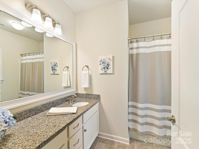 bathroom featuring baseboards, tile patterned flooring, and vanity