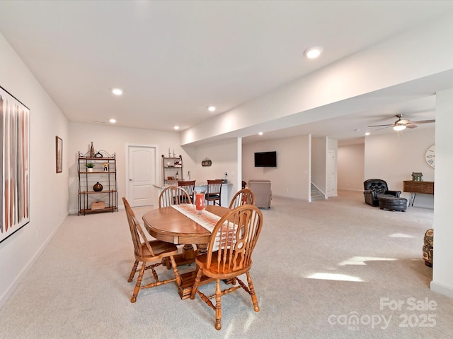 dining room featuring recessed lighting, carpet, a ceiling fan, baseboards, and stairs
