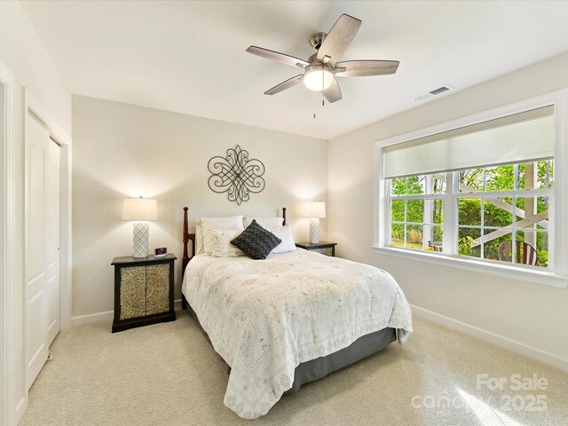 bedroom featuring ceiling fan, baseboards, visible vents, and carpet