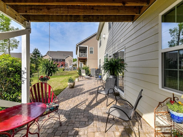 view of patio / terrace with a residential view and central AC unit