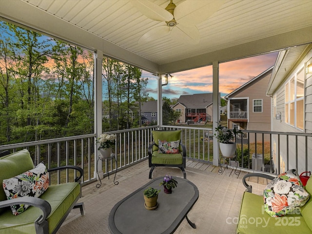 view of patio with ceiling fan and a balcony