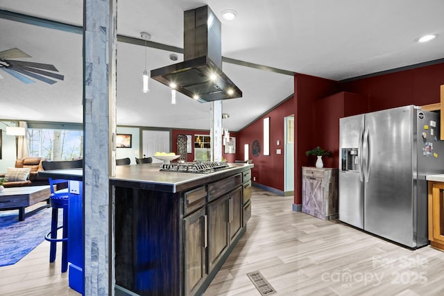 kitchen with visible vents, open floor plan, appliances with stainless steel finishes, light wood-style floors, and island exhaust hood