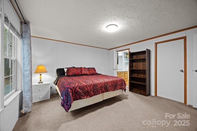 bedroom featuring ornamental molding, multiple windows, light carpet, and a textured ceiling