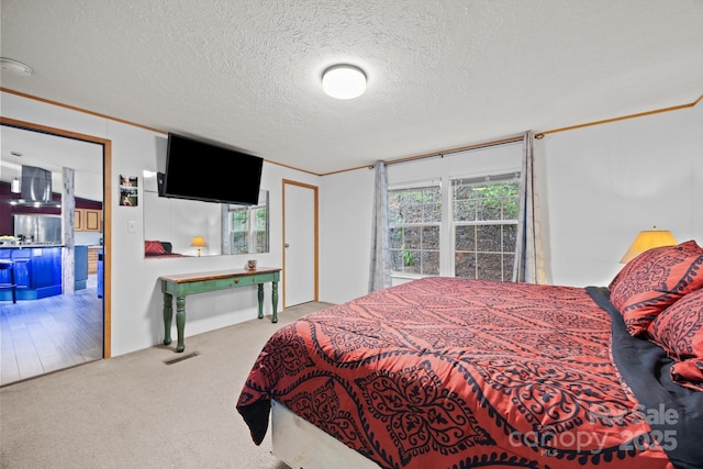 carpeted bedroom featuring crown molding, stainless steel fridge with ice dispenser, and a textured ceiling