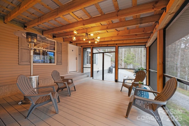 sunroom / solarium featuring beamed ceiling