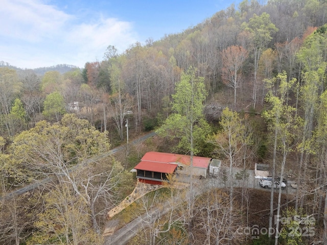 birds eye view of property featuring a view of trees