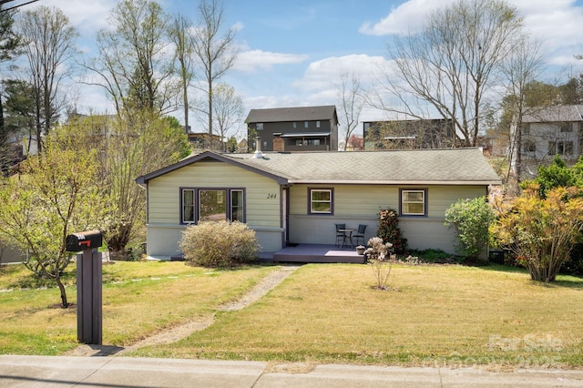 view of front of home with brick siding, a wooden deck, and a front lawn
