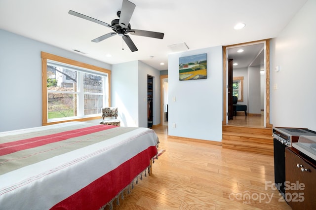 bedroom featuring a ceiling fan, a walk in closet, light wood finished floors, visible vents, and recessed lighting
