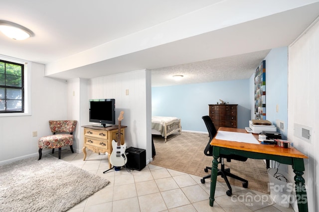 office space featuring light tile patterned flooring, baseboards, and light colored carpet