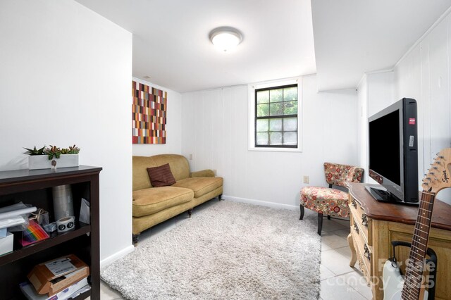 living area with baseboards and light tile patterned floors