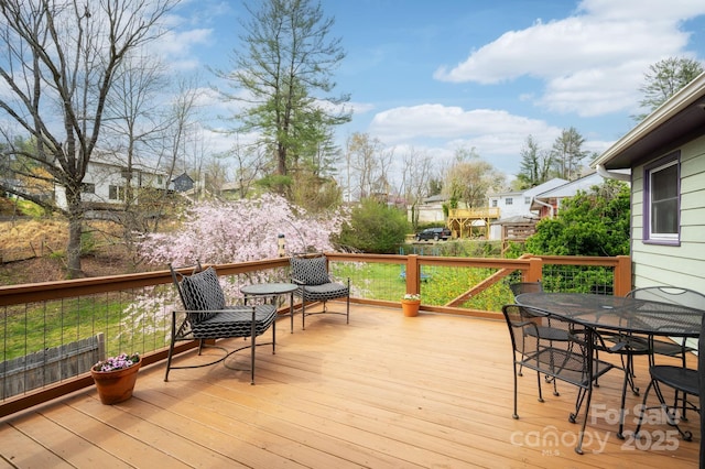 wooden terrace with outdoor dining area