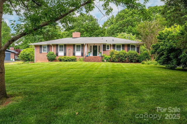 ranch-style house with a front lawn, a chimney, and brick siding