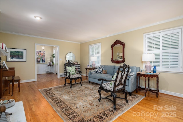 living room with baseboards, wood finished floors, and crown molding