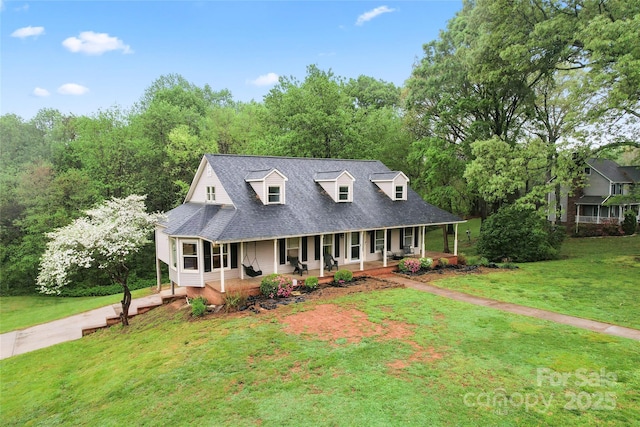 view of front of home with a shingled roof, a porch, and a front lawn
