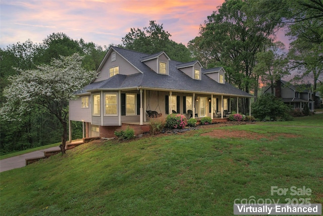 view of front facade featuring covered porch and a lawn
