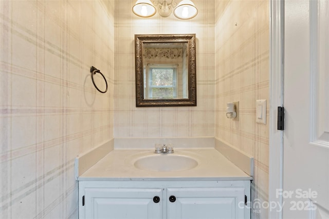 bathroom with vanity and an inviting chandelier