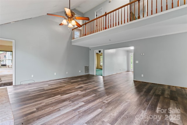 unfurnished living room with visible vents, ceiling fan, high vaulted ceiling, and wood finished floors