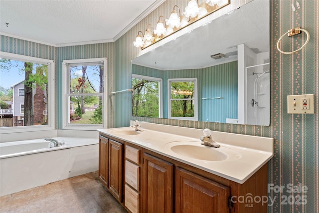 bathroom featuring wallpapered walls, a sink, and a garden tub