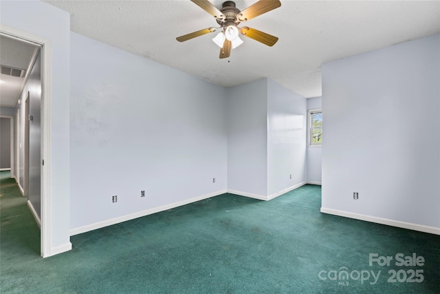 spare room featuring baseboards, ceiling fan, carpet, and a textured ceiling