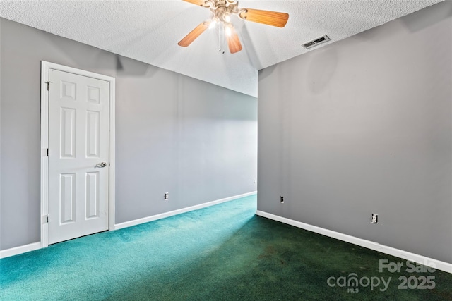 unfurnished room with baseboards, a textured ceiling, a ceiling fan, visible vents, and carpet