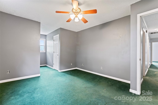 carpeted spare room featuring baseboards, visible vents, a textured ceiling, and a ceiling fan