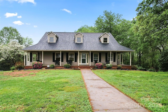 view of front of house featuring a porch, a shingled roof, and a front lawn