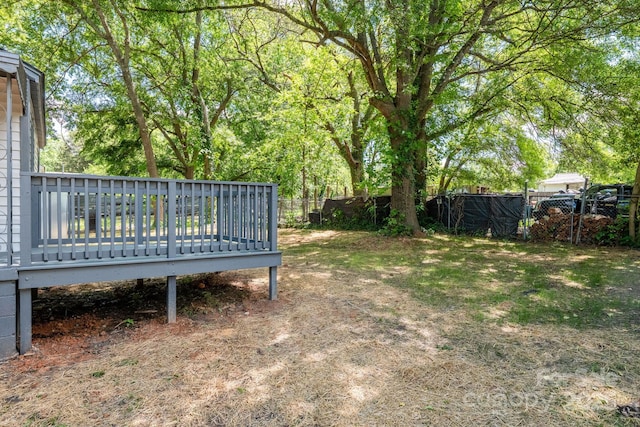 view of yard featuring fence and a wooden deck